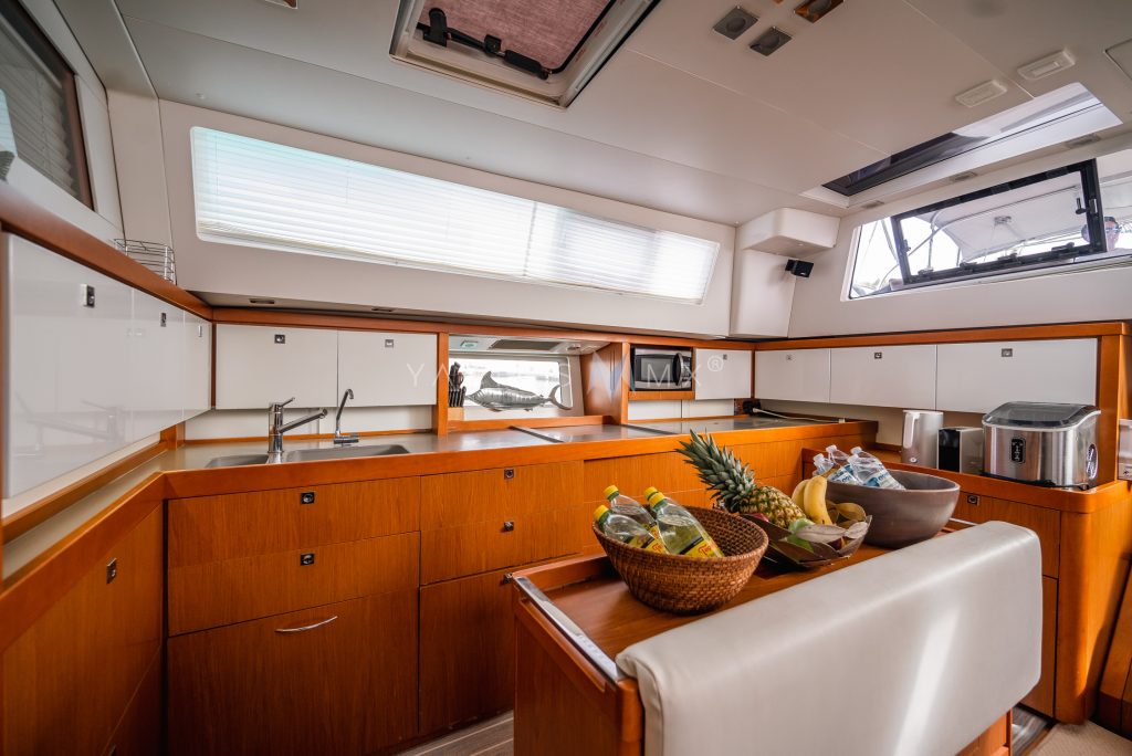 Beneteau 58 yacht charter La Paz - main salon and galley photo 03