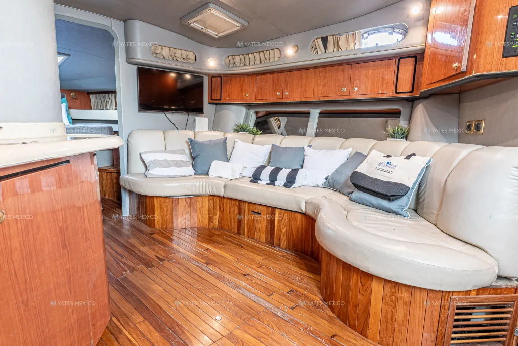 Sea Ray 45 yacht charter La Paz - air-conditioned salon with curved sofa and TV