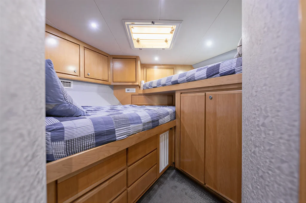Bertram 54 yacht charter La Paz - forward V-berth crossover cabin with twin bunks