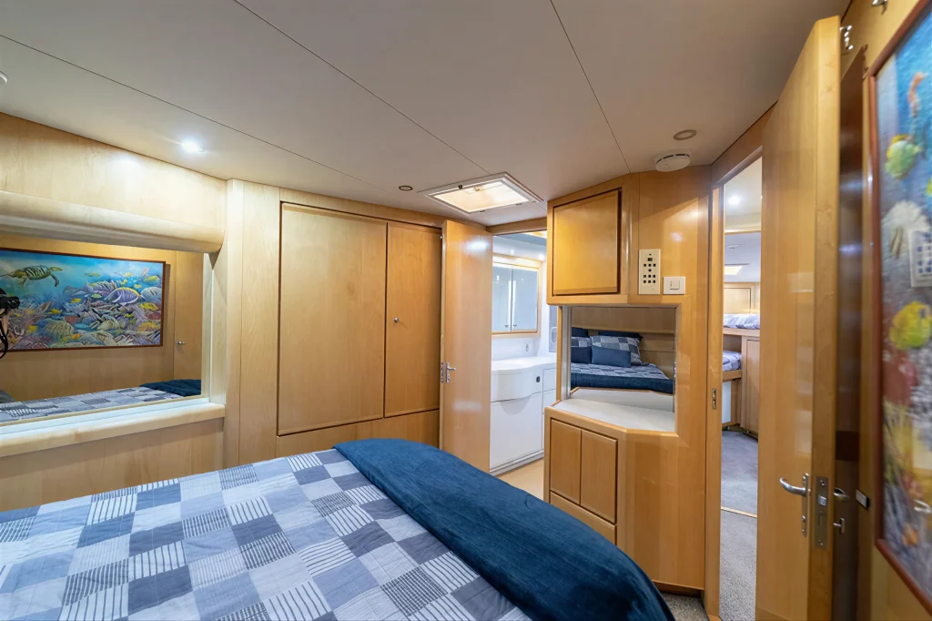 Bertram 54 yacht charter La Paz - guest stateroom with double berth and reef artwork