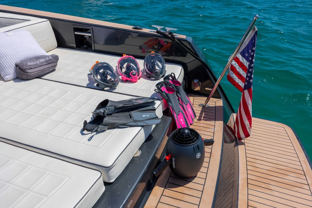 Snorkeling gear, masks and fins laid out on the sun pad of the VanDutch 42