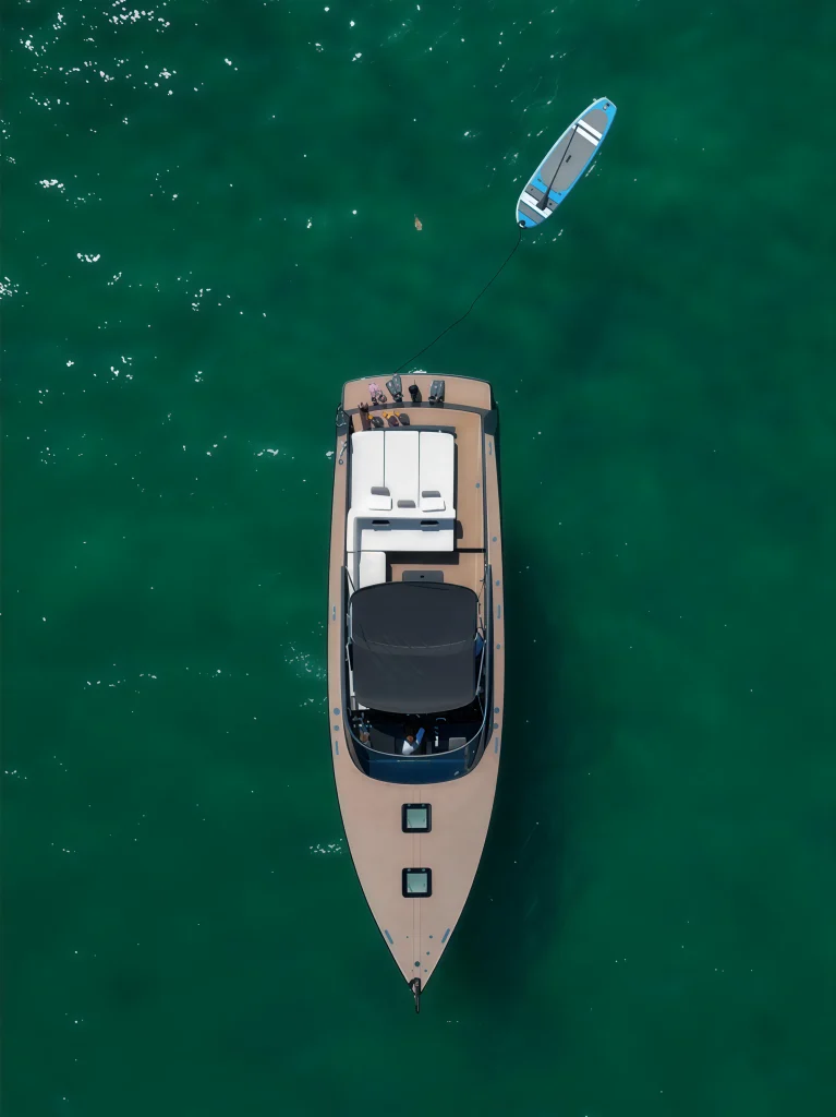 Top-down drone view of the VanDutch 42 anchored with the paddle board nearby
