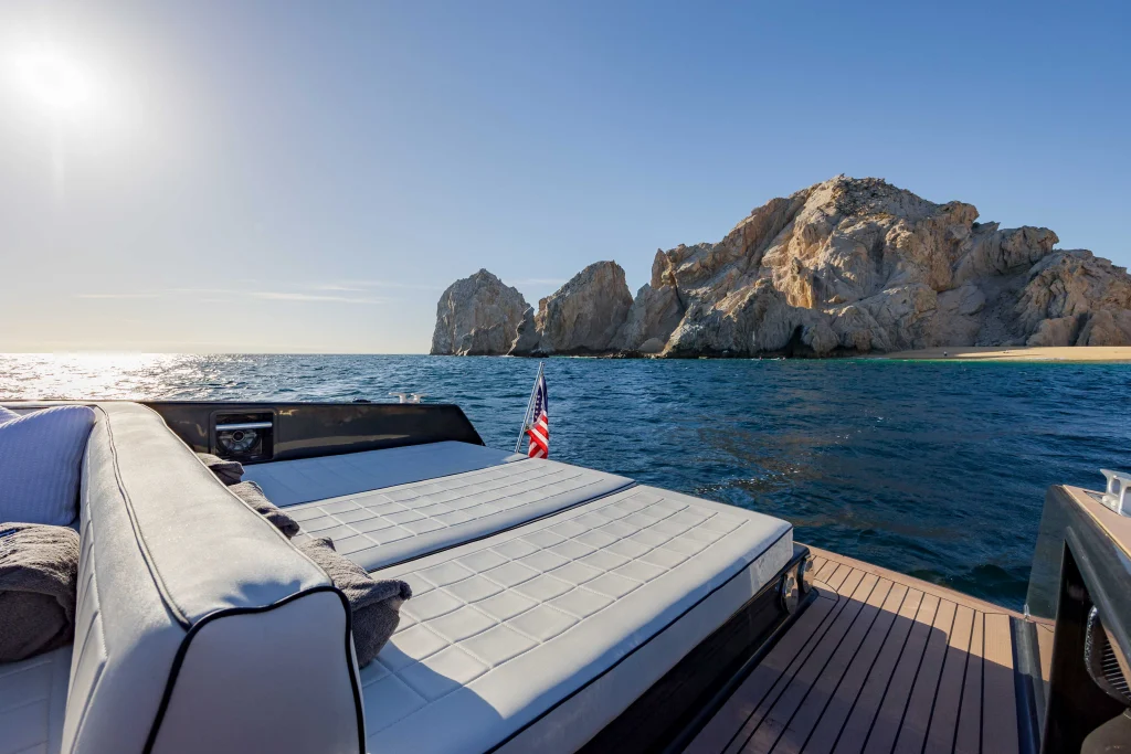 Bow sun pad of the VanDutch 42 with El Arco and Playa del Amor in view