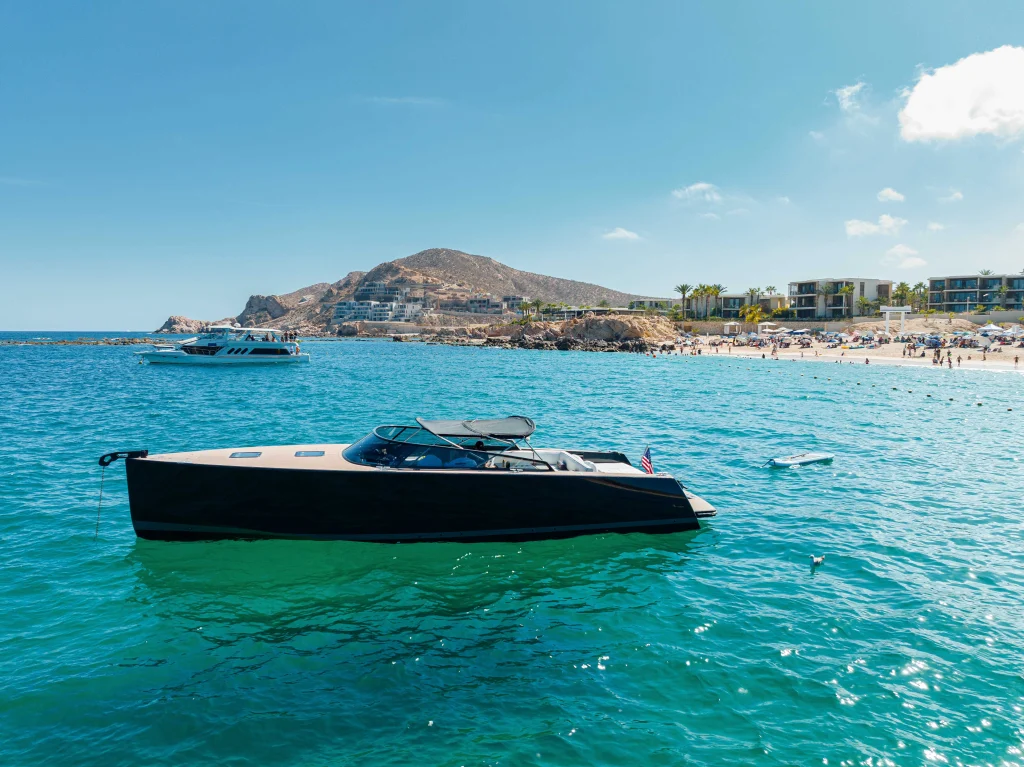 VanDutch 42 anchored off a Los Cabos beach with swimmers in the water
