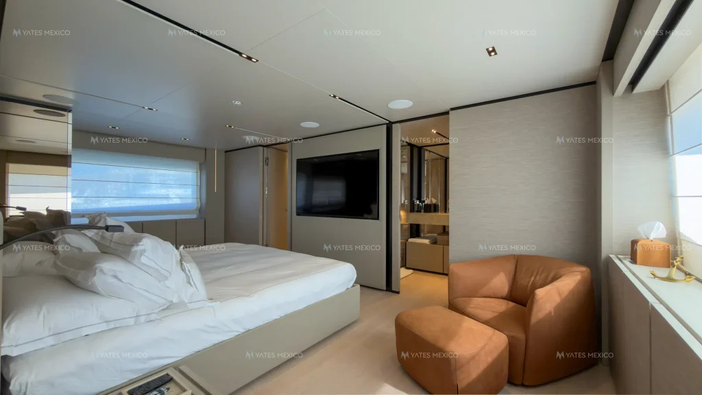 Custom Line 110 yacht charter La Paz - master suite with lounge chair and TV
