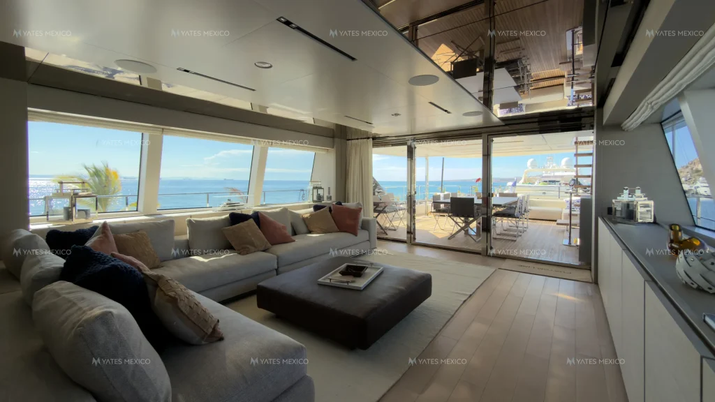 Custom Line 110 yacht charter La Paz - salon sofas opening to the aft deck