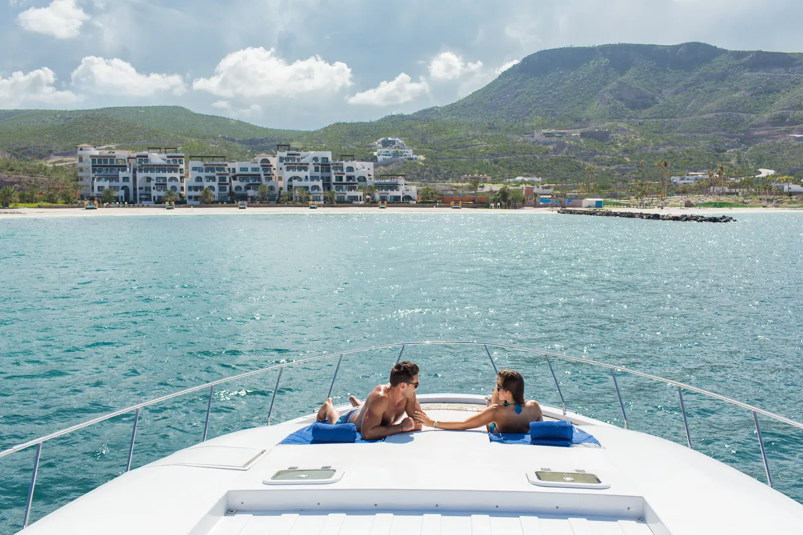Honeymoon Package 8 Couple lying on the bow sunbed of a private charter yacht in Baja California Sur