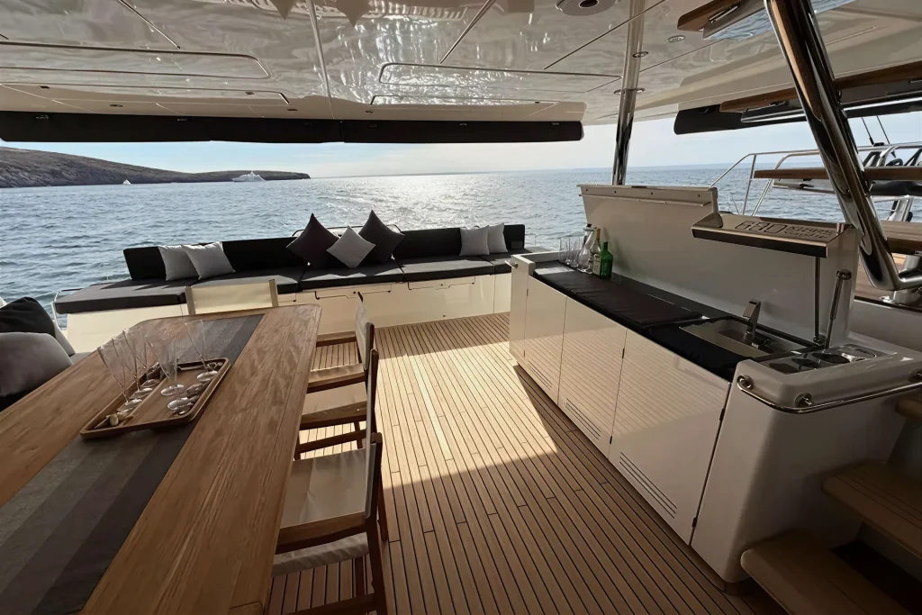 Teak aft cockpit with dining table at sunset aboard the Lagoon 63, La Paz