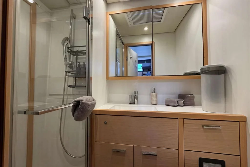 En-suite head with separate shower aboard the Lagoon 63 charter catamaran