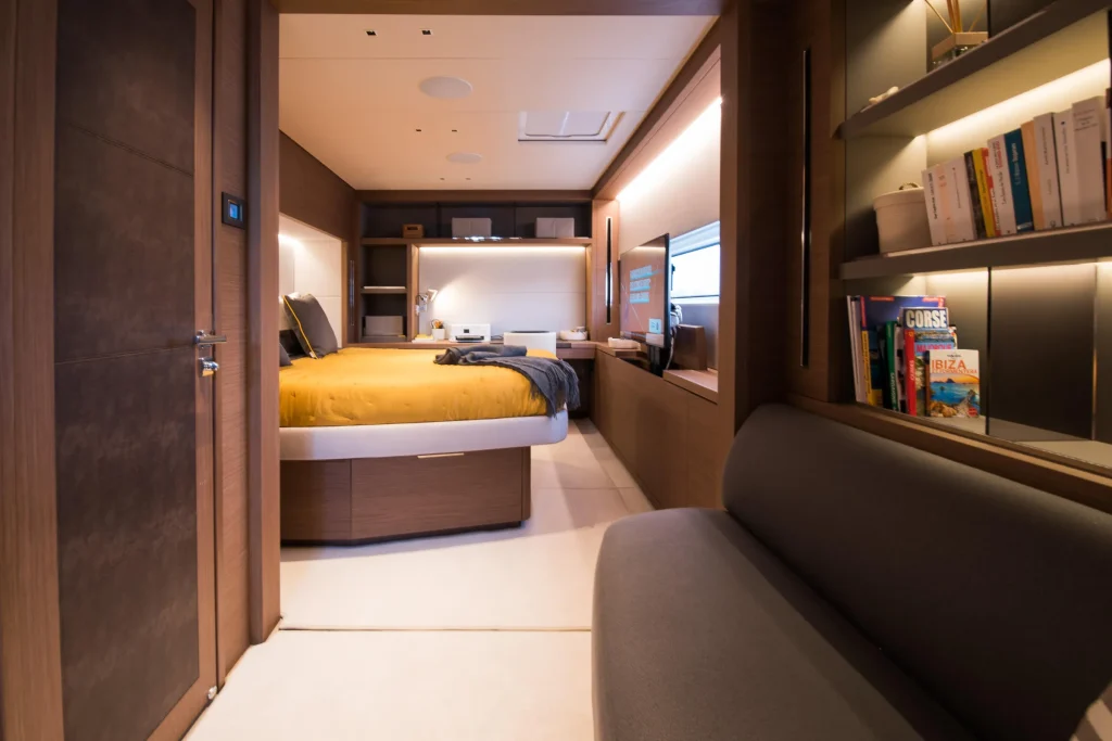 Double cabin with settee and bookshelves aboard the Lagoon 67