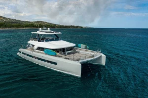 Lagoon 67 catamaran at anchor with the flybridge bimini extended