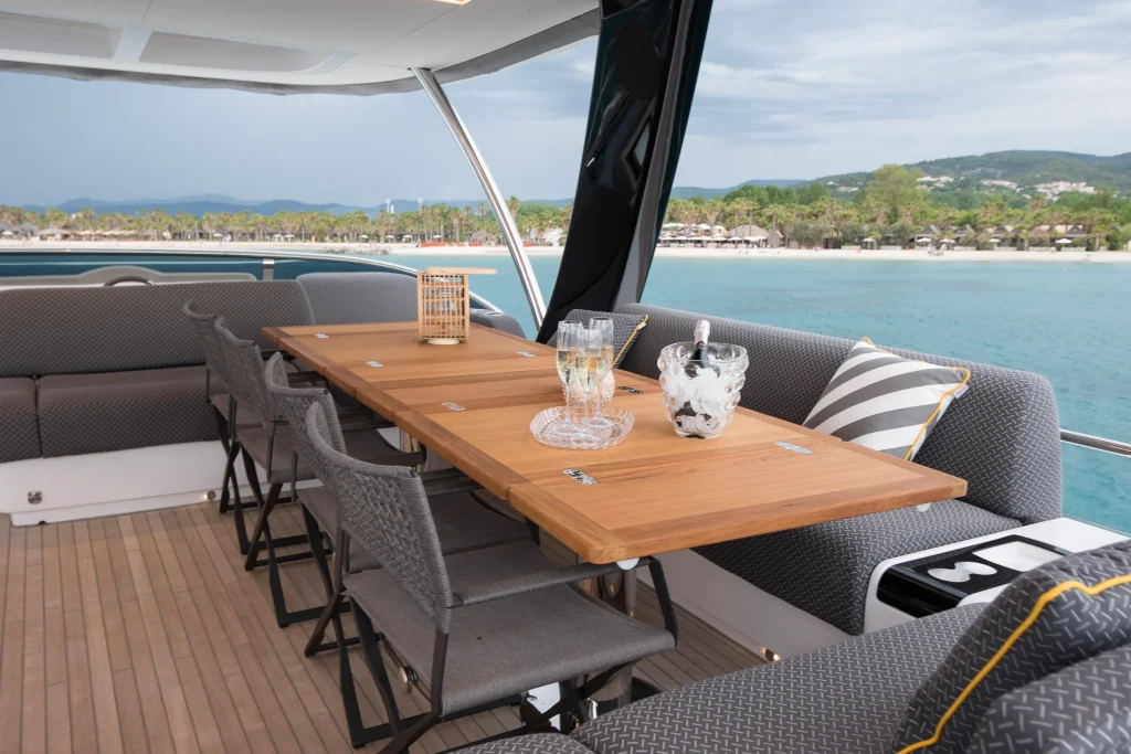 Teak flybridge dining table set for guests aboard the Lagoon 67