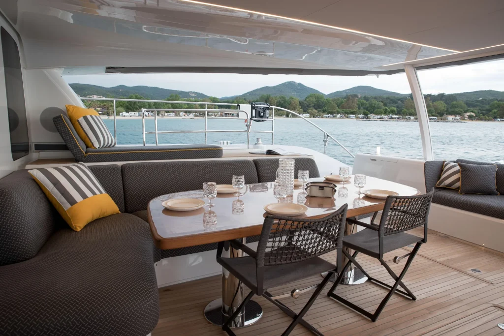 Aft deck dining area with cushioned seating on the Lagoon 67