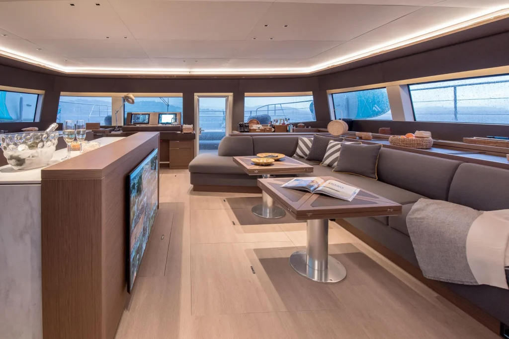 Main salon of the Lagoon 67 with panoramic windows and lounge seating
