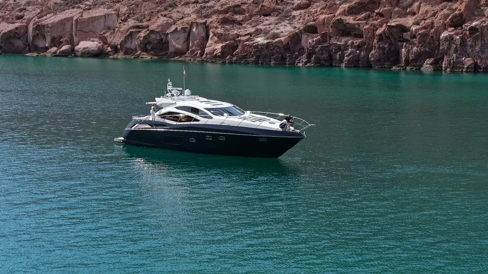 Sunseeker 64 yacht charter La Paz - at anchor below red volcanic cliffs